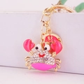 Pink crab keychain with sparkling rhinestones and a golden fortune coin charm - Pink
