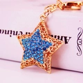 Cute golden star keychain with blue rhinestones on a decorative box accessory - Blue