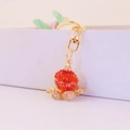 Portachiavi carrozza di zucca dorata con strass rossi e bianchi per borse da donna - Imballaggio Individuale / Arancione