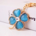 Sparkling four leaf clover keychain with blue opal stones and shiny crystal rhinestones - Blue