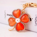 Luxurious four-leaf clover keychain with orange cat eye stones and sparkling rhinestones - Orange Red