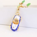 Blau-weißer Auto-Schlüsselanhänger mit Kristallen und goldenem Metallring im Detail - Blau
