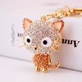 Cartoon cat keychain with white and amber rhinestones on a gold-plated metal chain - Amber