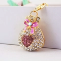 Gouden geldbuidelzak sleutelhanger met kristallen strass en roze strik detail - Paars