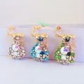 Three lucky money bag car keychains with colorful rhinestones and gold Fu character pendants - Random Color