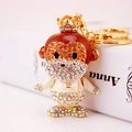 Exquisite gold monkey keychain with brown rhinestones and a small crown pendant - Iridescent