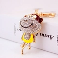 Charmant porte-clés singe doré orné de strass blancs avec un détail de ventre jaune - Jaune