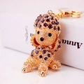 Sparkling purple rhinestone poodle keychain with golden metal finish and crystal charms - Violet
