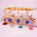 Porte-clés œil grec étincelants en métal doré avec pendentifs en pierres colorées - Couleur Aléatoire