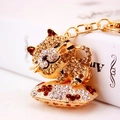 Goldener Leoparden-Schlüsselanhänger mit Champagner-Strass und floralen Elementen - Kaffeebraun