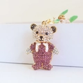 Creative bear keychain with purple and white rhinestones on a gold metal base - Purple