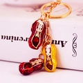 Traditional Chinese style peanut keychain with red and yellow enamel pendants and crystals - Red