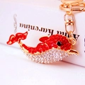 Cute gold-plated dolphin keychain featuring sparkling red and white rhinestones and ring - Red