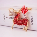 Porte-clés Kirin style chinois doré avec strass rouges et émail sur un livre élégant - Rouge