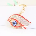 Exquisite Evil Eye keychain with golden alloy base and sparkling white rhinestones for bags - Red