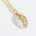 Minimalist golden rugby shell pendant necklace with sparkling cubic zirconia and white enamel - White
