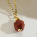 Minimalist gold necklace featuring a multifaceted red agate geometric gemstone pendant - Red Brown