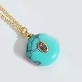 Blue turquoise round necklace with center purple stone and golden cross chain - Blue