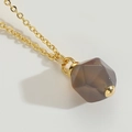 Minimalist gold necklace featuring a multifaceted dark brown geometric gemstone pendant - Brown
