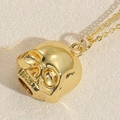 Polished gold skull pendant necklace with mirror finish on fine cross chain link - Skull