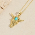 Vintage gold bull head pendant necklace with turquoise stone on desert sand background - Turquoise (Gold)