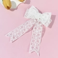 Detail of elegant white lace bow hair clip with floral patterns and long ribbons - White Long Ribbon Bow