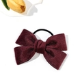 Detail of burgundy velvet bow hair tie with elastic band on a clean white background - Burgundy