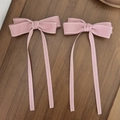Elegant pair of pink bow hair clips with white stitched edges on a bamboo tray - Bow Ribbon Style / Pink