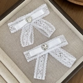 Lace bow hair clips with rhinestone hearts on a beige fabric jewelry display tray - White (1 Pair)