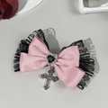 Close-up of pink satin bow hair clip with black lace, heart gem, and silver cross charm - Pink