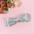 Macro view of light blue satin bow hair clip featuring silky texture and layered design - Blue