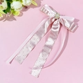 Dettaglio del fermaglio a fiocco in raso rosa a pois neri con perla e strass lucidi - Rosa