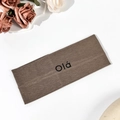 Detail of a brown ribbed knit sports headband featuring black Olá printed text - Dark Coffee