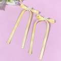 Detailed close-up of yellow satin ribbon hair clips with white daisy flower embroidery - Yellow (Pair)