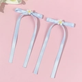 Detail of light blue ribbon bows with white embroidered daisy flowers for hair decoration - Blue (Pair)
