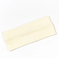 Close-up detail of the ribbed texture on a beige knitted yoga elastic headband - Beige