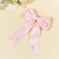 Détail d'un nœud papillon en satin rose avec de délicates broderies de marguerites - Rose (Style Long)