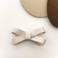 Minimalist cream ribbon bow hair clip with ribbed texture on clean aesthetic background - Beige Grey