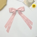 Detail view of large pink satin double-layered bow hair clip with long ribbons - Pink