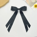 Detail of elegant black double-layered satin bow hair clip with long ribbons on gray stone - Black