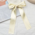 Elegant champagne satin bow hair clip with long ribbons and silky texture finish - Off White