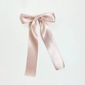 Close-up of elegant champagne pink satin bow hair clip with long silk streamers - Deep Pink