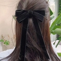 Elegante molletta per capelli in velluto nero con lunghi nastri su modella all'aperto - Nero