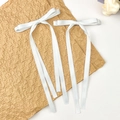 Detalle de pinzas para el cabello con lazos de satén blanco en papel de corazones - Blanco