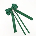 Detail view of dark green satin bow hair clip with elegant long ribbon streamers - Christmas Green