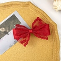Elegant red double-layer lace and satin bow hair clip on a textured gold display tray - Red