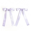 Detail of lavender satin ribbon hair bows with long elegant streamers and silky texture - Purple