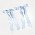 Detail of light blue satin ribbon bow hair clips with long streamers for elegant hair styling - Blue