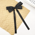 Elegant solid black satin bow hair clip with long streamers and smooth silky texture - Black