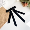 Detalle de elegante pasador de lazo de terciopelo negro con cintas largas suaves - Negro